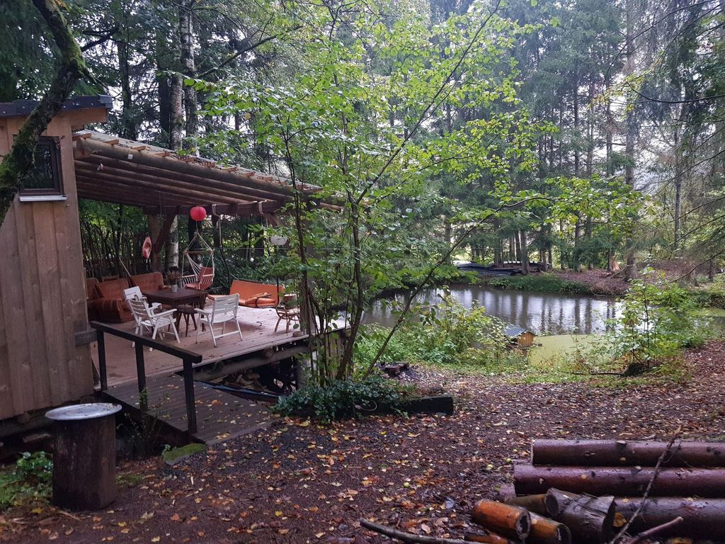 Cabin in forest with pond