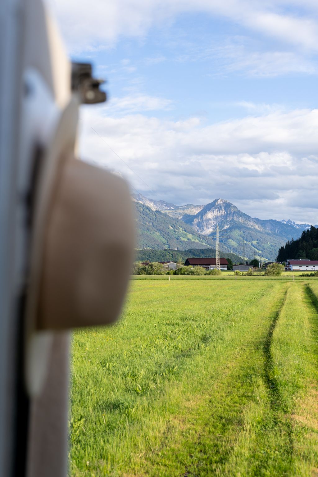 Mountain panorama between fields and meadow path